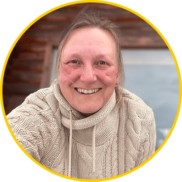 Smiling person in a cozy knit sweater.
